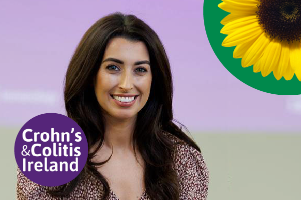 Amy Kelly has white skin and long black hair. The Crohn's & Colitis Ireland Logo and a Sunflower.