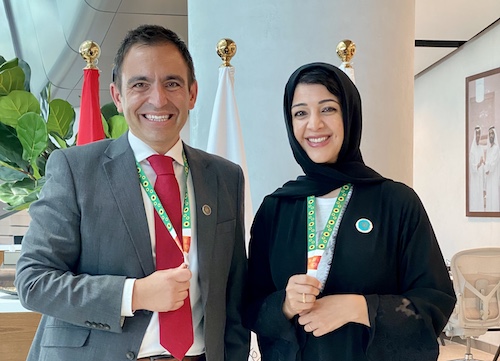 An image of Steven with her Excellency, the leader general of Expo. They wear Hidden Disabilities Sunflower lanyards. 